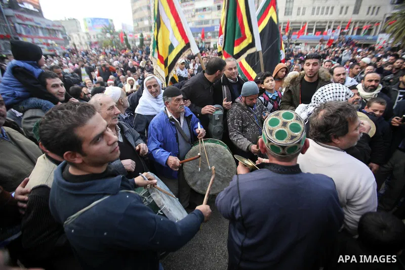 Palestinians Muslim Sufis play musical instruments as they parade through the streets during a ceremony commemorating the birth of Prophet Mohammed, known in Arabic as "Mawlid al-Nabawi", in the West Bank city of Nablus...