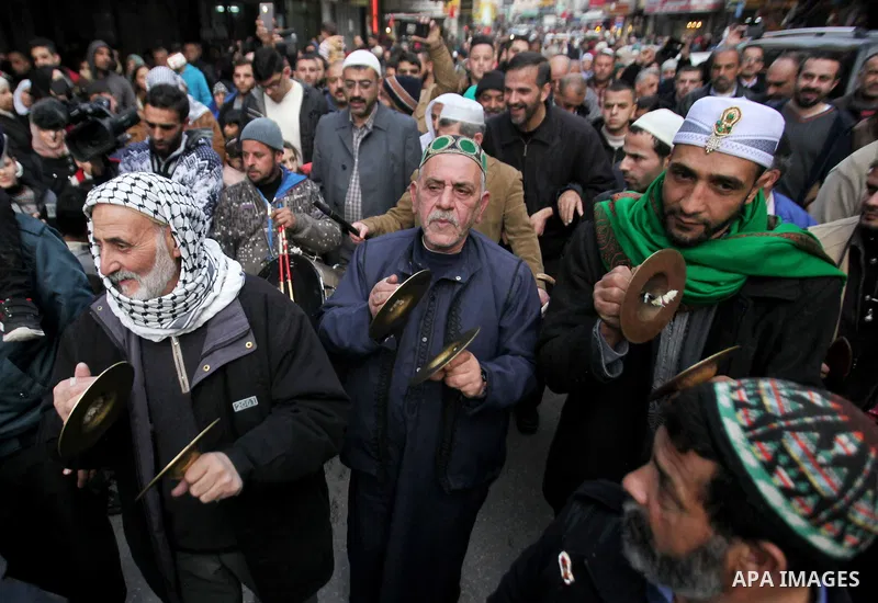 Palestinians Muslim Sufis play musical instruments as they parade through the streets during a ceremony commemorating the birth of Prophet Mohammed, known in Arabic as "Mawlid al-Nabawi", in the West Bank city of Nablus...