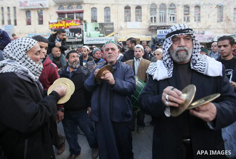 Palestinians Muslim Sufis play musical instruments as they parade through the streets during a ceremony commemorating the birth of Prophet Mohammed, known in Arabic as "Mawlid al-Nabawi", in the West Bank city of Nablus...