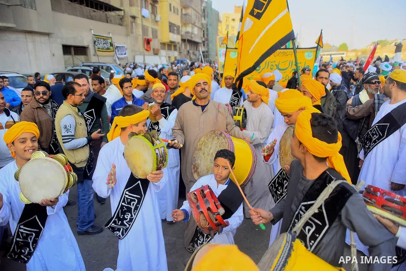 Egyptian Sufi Muslims chant prayers while walking in a march with banners as they celebrate "Mawlid al-Nabawi" or the birth of Prophet Mohammad, in old Cairo, Egypt, on December 11, 2016. Photo by Amr Sayed