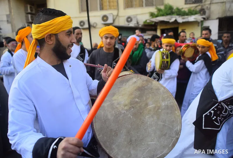 Egyptian Sufi Muslims chant prayers while walking in a march with banners as they celebrate "Mawlid al-Nabawi" or the birth of Prophet Mohammad, in old Cairo, Egypt, on December 11, 2016. Photo by Amr Sayed