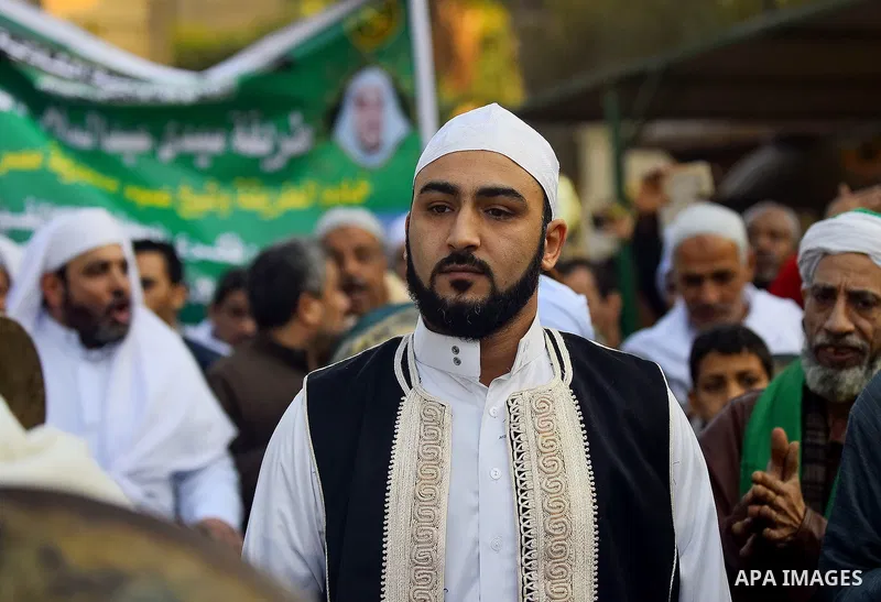 Egyptian Sufi Muslims chant prayers while walking in a march with banners as they celebrate "Mawlid al-Nabawi" or the birth of Prophet Mohammad, in old Cairo, Egypt, on December 11, 2016. Photo by Amr Sayed