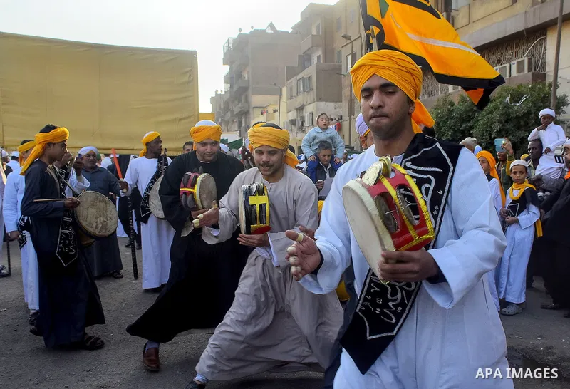 Egyptian Sufi Muslims chant prayers while walking in a march with banners as they celebrate "Mawlid al-Nabawi" or the birth of Prophet Mohammad, in old Cairo, Egypt, on December 11, 2016. Photo by Amr Sayed