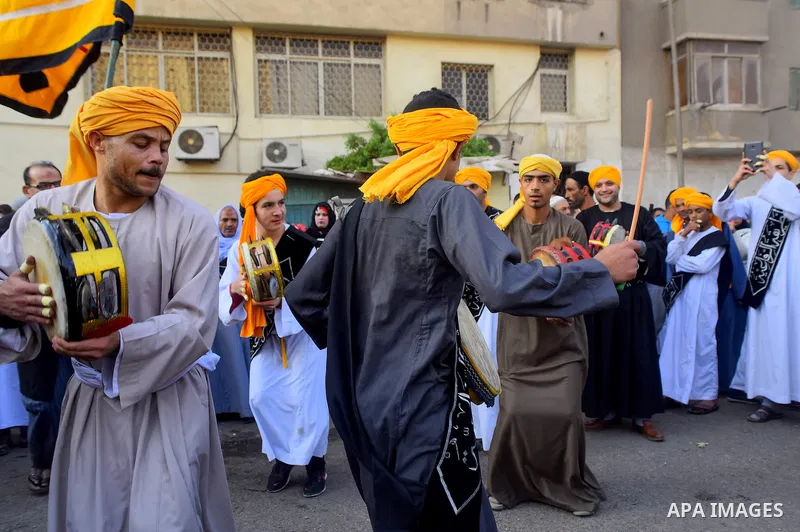 Egyptian Sufi Muslims chant prayers while walking in a march with banners as they celebrate "Mawlid al-Nabawi" or the birth of Prophet Mohammad, in old Cairo, Egypt, on December 11, 2016. Photo by Amr Sayed