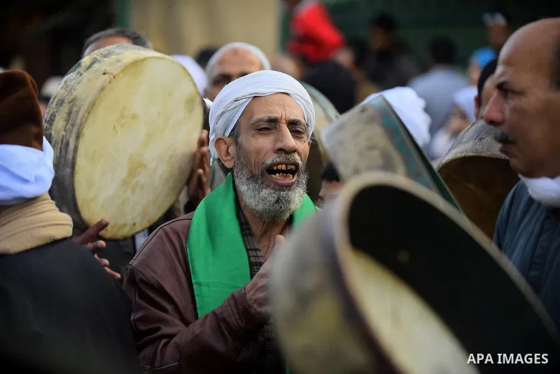 Egyptian Sufi Muslims chant prayers while walking in a march with banners as they celebrate "Mawlid al-Nabawi" or the birth of Prophet Mohammad, in old Cairo, Egypt, on December 11, 2016. Photo by Amr Sayed