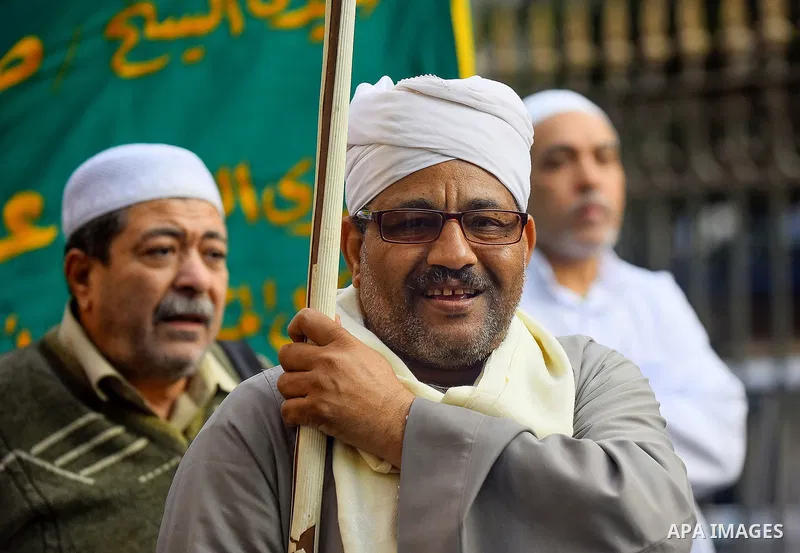 Egyptian Sufi Muslims chant prayers while walking in a march with banners as they celebrate "Mawlid al-Nabawi" or the birth of Prophet Mohammad, in old Cairo, Egypt, on December 11, 2016. Photo by Amr Sayed