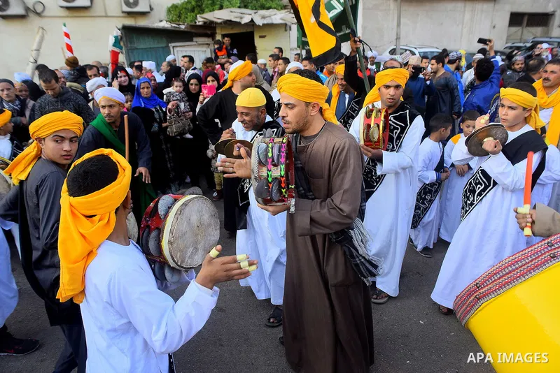 Egyptian Sufi Muslims chant prayers while walking in a march with banners as they celebrate "Mawlid al-Nabawi" or the birth of Prophet Mohammad, in old Cairo, Egypt, on December 11, 2016. Photo by Amr Sayed