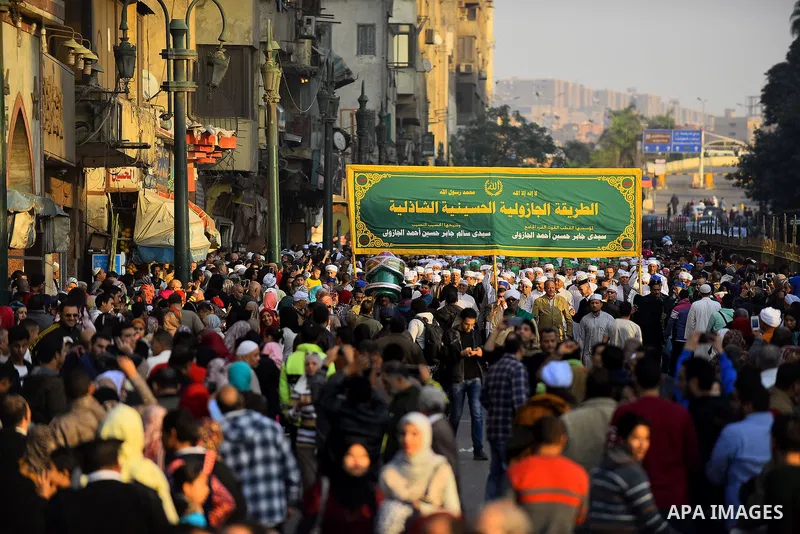 Egyptian Sufi Muslims chant prayers while walking in a march with banners as they celebrate "Mawlid al-Nabawi" or the birth of Prophet Mohammad, in old Cairo, Egypt, on December 11, 2016. Photo by Amr Sayed