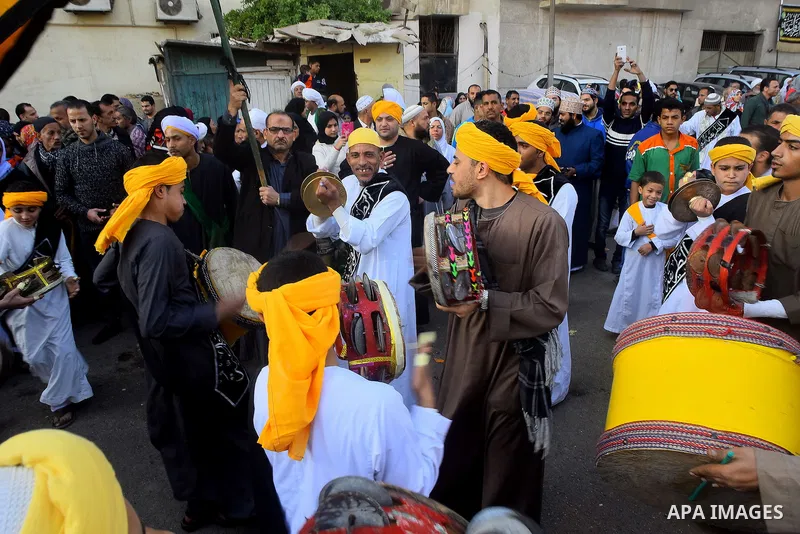Egyptian Sufi Muslims chant prayers while walking in a march with banners as they celebrate "Mawlid al-Nabawi" or the birth of Prophet Mohammad, in old Cairo, Egypt, on December 11, 2016. Photo by Amr Sayed