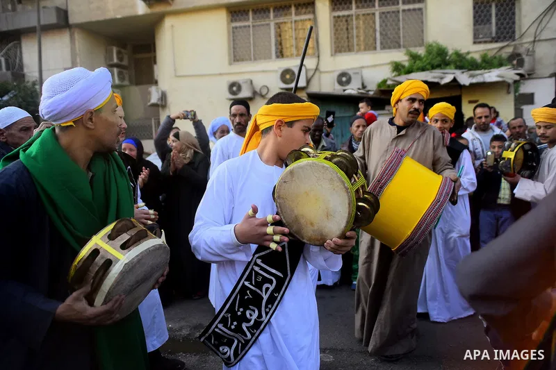 Egyptian Sufi Muslims chant prayers while walking in a march with banners as they celebrate "Mawlid al-Nabawi" or the birth of Prophet Mohammad, in old Cairo, Egypt, on December 11, 2016. Photo by Amr Sayed