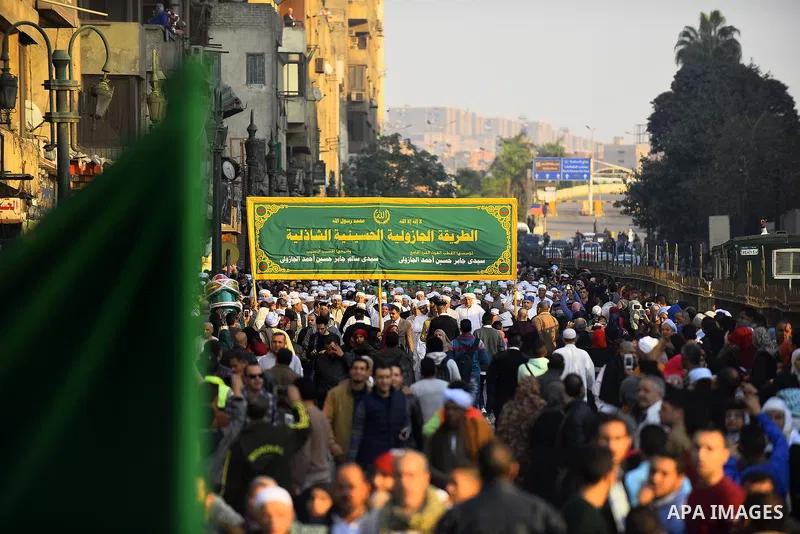 Egyptian Sufi Muslims chant prayers while walking in a march with banners as they celebrate "Mawlid al-Nabawi" or the birth of Prophet Mohammad, in old Cairo, Egypt, on December 11, 2016. Photo by Amr Sayed