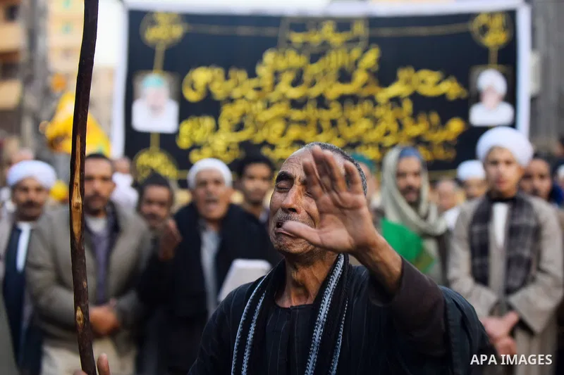 Egyptian Sufi Muslims chant prayers while walking in a march with banners as they celebrate "Mawlid al-Nabawi" or the birth of Prophet Mohammad, in old Cairo, Egypt, on December 11, 2016. Photo by Amr Sayed