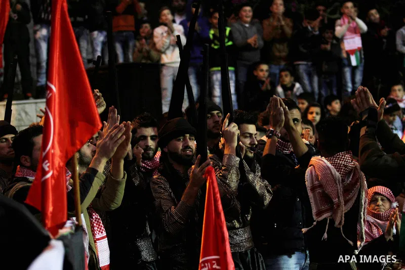 Palestinians take part in a rally marking the 49th anniversary of the founding of the Popular Front for the Liberation of Palestine (PFLP), in the village of Asira Shamaliya, north of the West Bank city of Nablus on 12 D...