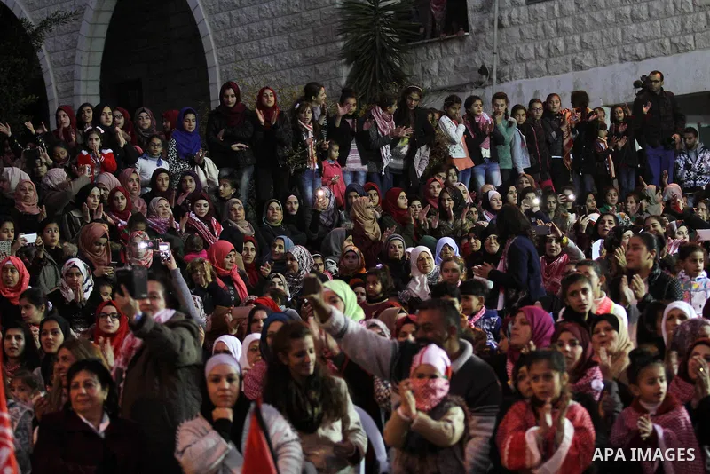 Palestinians take part in a rally marking the 49th anniversary of the founding of the Popular Front for the Liberation of Palestine (PFLP), in the village of Asira Shamaliya, north of the West Bank city of Nablus on 12 D...