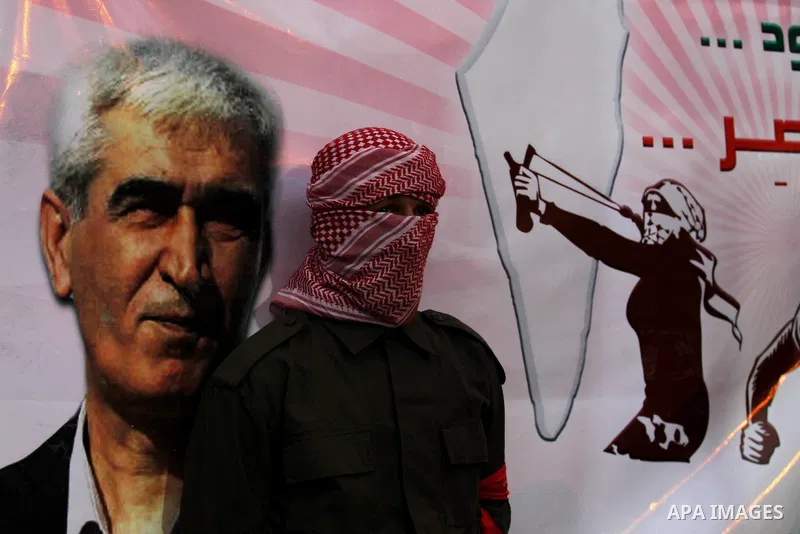 Palestinians take part in a rally marking the 49th anniversary of the founding of the Popular Front for the Liberation of Palestine (PFLP), in the village of Asira Shamaliya, north of the West Bank city of Nablus on 12 D...