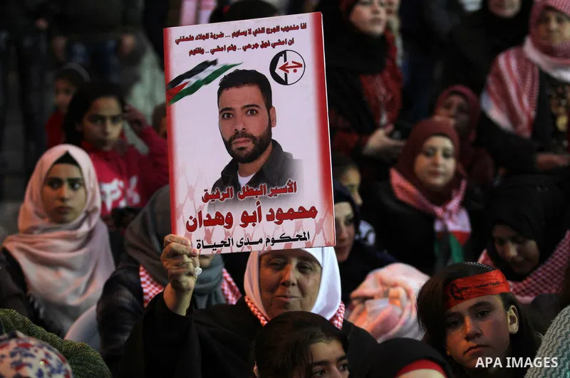 Palestinians take part in a rally marking the 49th anniversary of the founding of the Popular Front for the Liberation of Palestine (PFLP), in the village of Asira Shamaliya, north of the West Bank city of Nablus on 12 D...