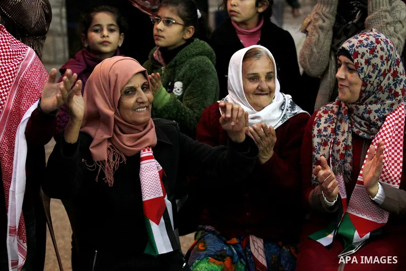 Palestinians take part in a rally marking the 49th anniversary of the founding of the Popular Front for the Liberation of Palestine (PFLP), in the village of Asira Shamaliya, north of the West Bank city of Nablus on 12 D...