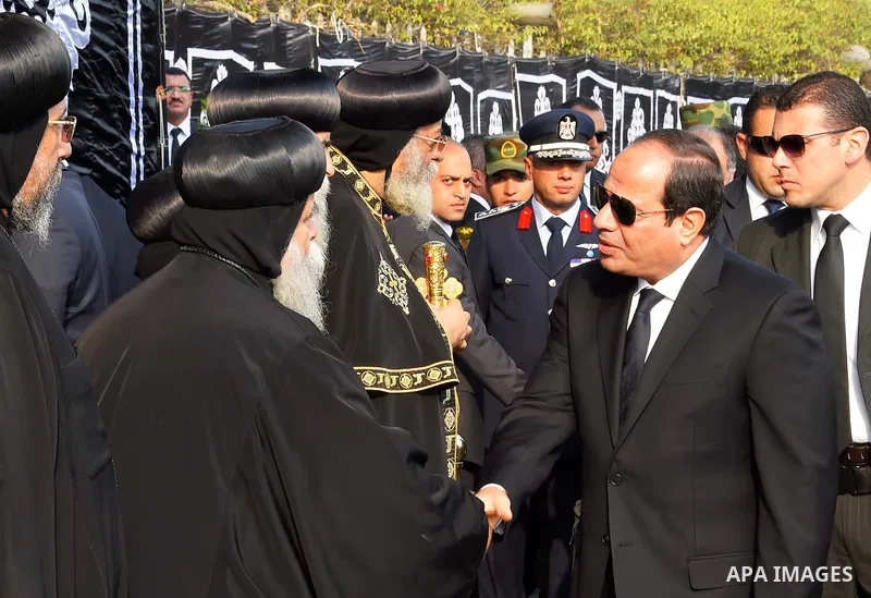 Egyptian President Abdel Fattah al-Sisi offers his condolences to Egypt's Coptic Pope Tawadros II in the end of the funeral of the victims of a bomb explosion that targeted a Coptic Orthodox Church in Cairo on December 1...