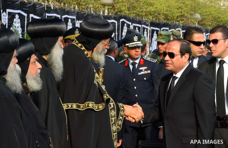 Egyptian President Abdel Fattah al-Sisi offers his condolences to Egypt's Coptic Pope Tawadros II in the end of the funeral of the victims of a bomb explosion that targeted a Coptic Orthodox Church in Cairo on December 1...