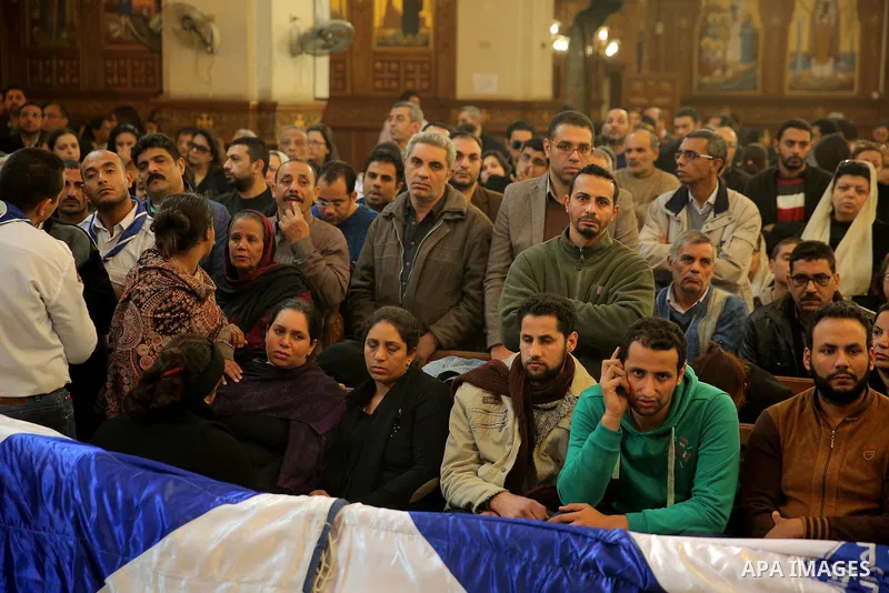 Egyptian Christians attend the funeral of the victims of a bomb explosion that targeted a Coptic Orthodox Church the previous day in Cairo, in the Egyptian capital's Nassr City neighbourhood on December 12, 2016. Photo b...