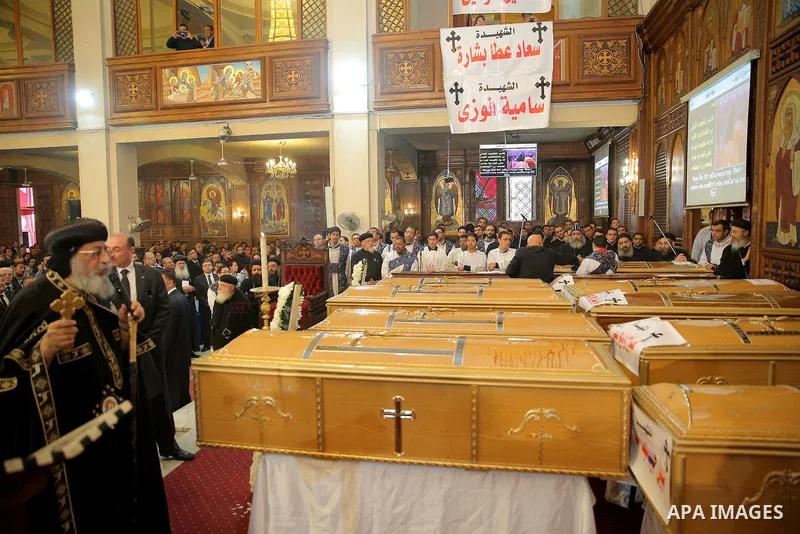 Egypt's Coptic Pope Tawadros II leads the funeral of the victims of a bomb explosion that targeted a Coptic Orthodox Church the previous day in Cairo, during their funeral in the Egyptian capital's Nassr City neighbourho...