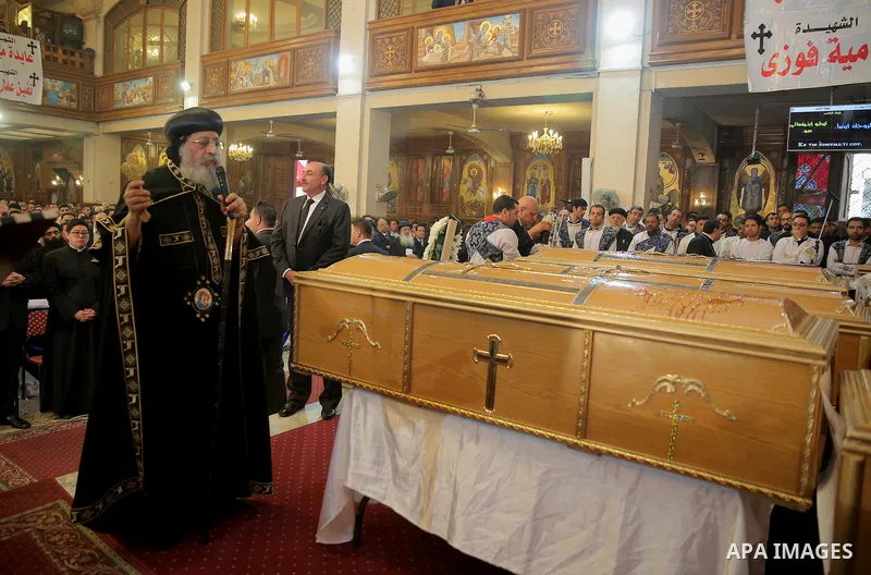 Egypt's Coptic Pope Tawadros II leads the funeral of the victims of a bomb explosion that targeted a Coptic Orthodox Church the previous day in Cairo, during their funeral in the Egyptian capital's Nassr City neighbourho...