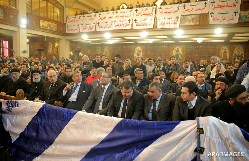 Egyptian Christians attend the funeral of the victims of a bomb explosion that targeted a Coptic Orthodox Church the previous day in Cairo, in the Egyptian capital's Nassr City neighbourhood on December 12, 2016. Photo b...