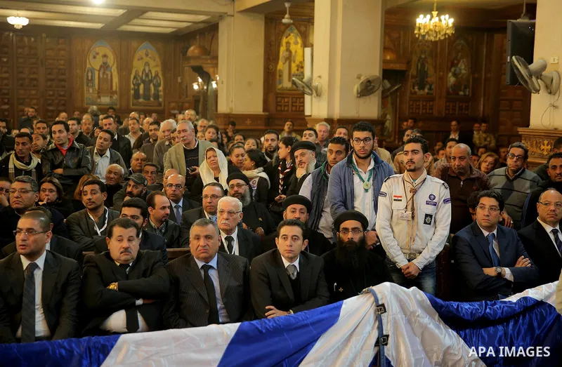 Egyptian Christians attend the funeral of the victims of a bomb explosion that targeted a Coptic Orthodox Church the previous day in Cairo, in the Egyptian capital's Nassr City neighbourhood on December 12, 2016. Photo b...