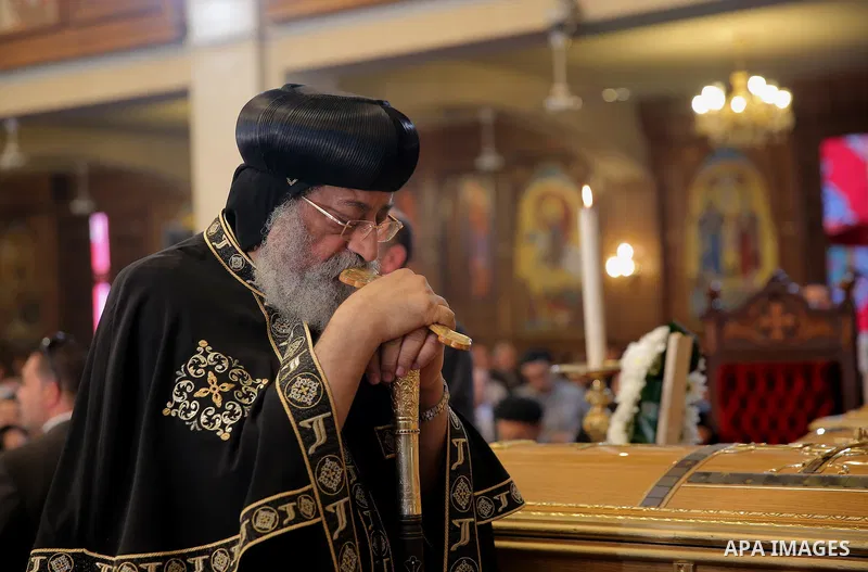 Egypt's Coptic Pope Tawadros II leads the funeral of the victims of a bomb explosion that targeted a Coptic Orthodox Church the previous day in Cairo, during their funeral in the Egyptian capital's Nassr City neighbourho...