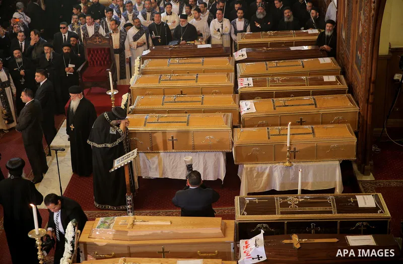 Egypt's Coptic Pope Tawadros II leads the funeral of the victims of a bomb explosion that targeted a Coptic Orthodox Church the previous day in Cairo, during their funeral in the Egyptian capital's Nassr City neighbourho...