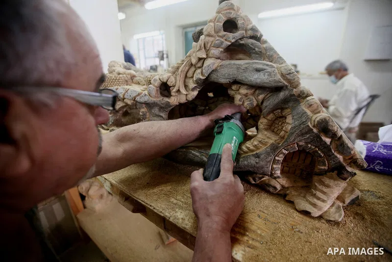 A Palestinian carpenter carves a wooden effigies of the the Holy Family at a workshop in the West Bank town of Bethlehem, on December 13, 2016. The traditional birthplace of Jesus Christ prepares to celebrate Christmas l...