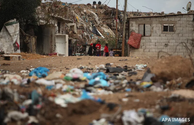 Palestinian children play outside their family's shanty during the winter storm in Khan Younis, in the southern Gaza Strip on December 14, 2016. Photo by Ashraf Amra
