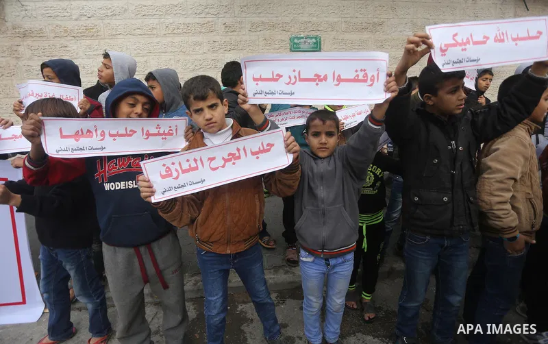 Palestinian childern hold banners during a demonstration in solidarity with the inhabitants of the embattled Syrian city of Aleppo, in front of Red Cross, in Gaza city, on December 14, 2016. Photo by Mohammed Asad