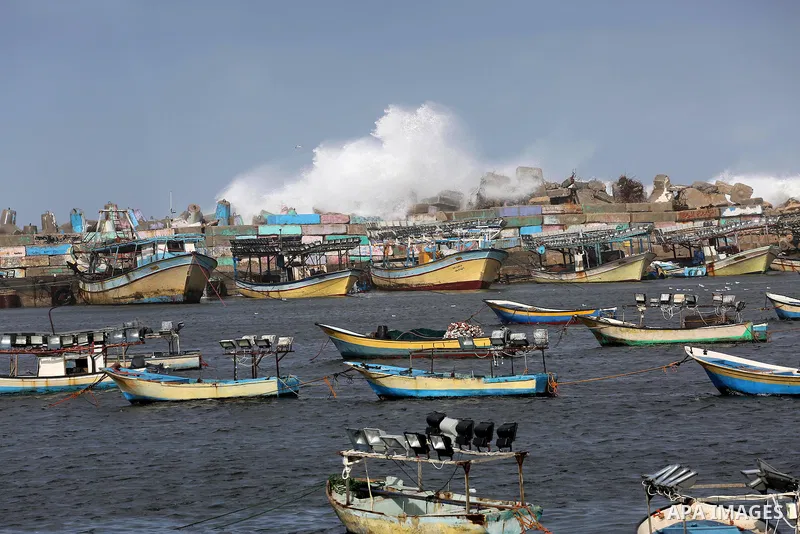 A huge wave is seen crash over a sea wall at the Gaza seaport during a stormy day, in Gaza city on December 14, 2016. Photo by Mohammed Asad