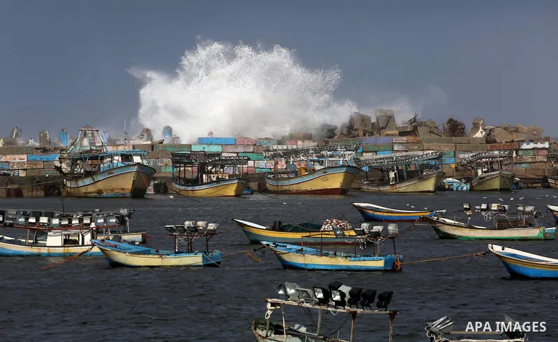 A huge wave is seen crash over a sea wall at the Gaza seaport during a stormy day, in Gaza city on December 14, 2016. Photo by Mohammed Asad
