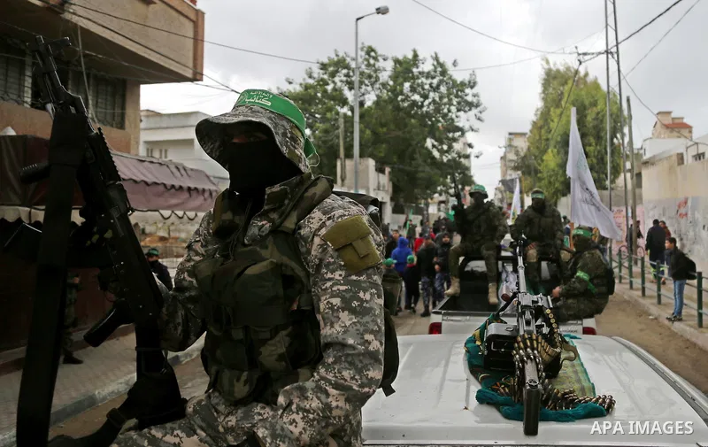 Palestinian militants take part in a rally marking the 29th anniversary of the founding of the Hamas movement, in Gaza city December 14, 2016. Photo by Ashraf Amra