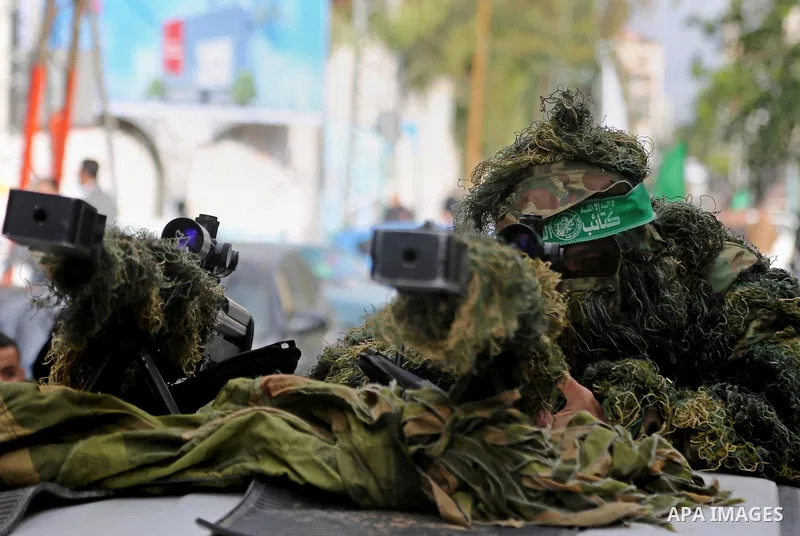 Palestinian militants take part in a rally marking the 29th anniversary of the founding of the Hamas movement, in Gaza city December 14, 2016. Photo by Ashraf Amra