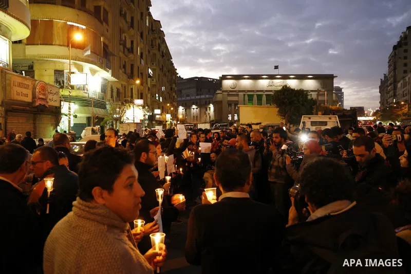 Egyptian Muslims and Christians hold lighted candles in downtown Cairo, following a deadly explosion inside a Coptic cathedral in Cairo, Egypt December 14, 2016. Photo by Amr Sayed