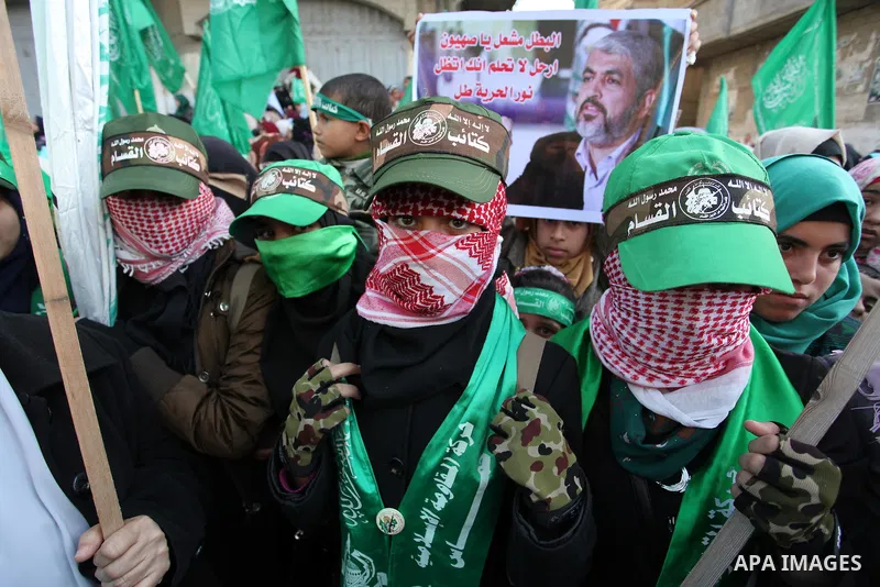 Palestinian Hamas supporters take part during a rally marking the 29th anniversary of the founding of the Hamas movement, in Nuseirat refugee camp in the central Gaza Strip, December 16, 2016. . Photo by Ashraf Amra