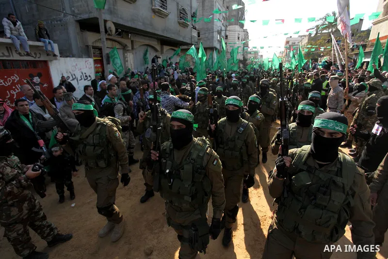 Palestinian Hamas militants take part in a rally marking the 29th anniversary of the founding of the Hamas movement in Nuseirat refugee camp in the central Gaza Strip, December 16, 2016. Photo by Ashraf Amra