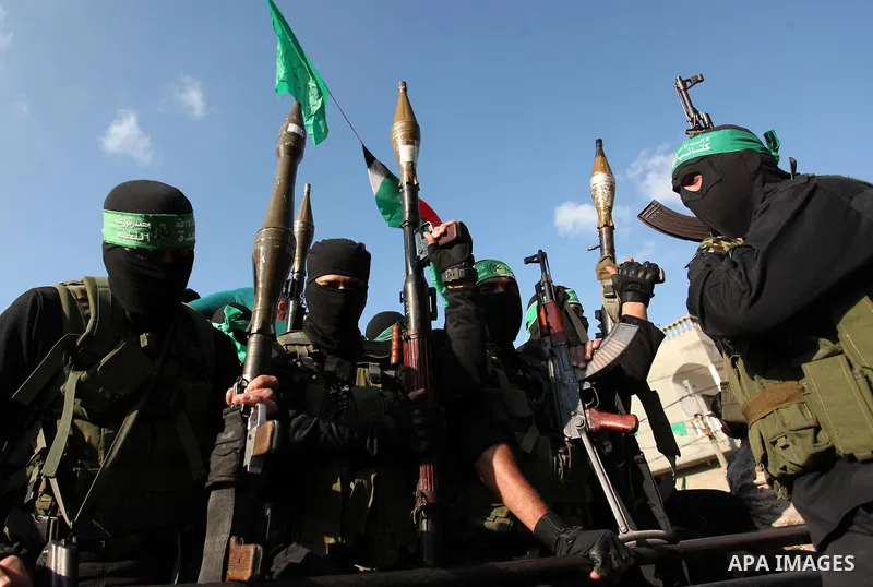 Palestinian Hamas militants take part in a rally marking the 29th anniversary of the founding of the Hamas movement in Nuseirat refugee camp in the central Gaza Strip, December 16, 2016. Photo by Ashraf Amra