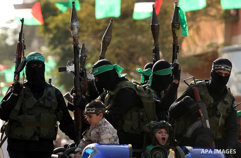 Palestinian Hamas militants take part in a rally marking the 29th anniversary of the founding of the Hamas movement in Nuseirat refugee camp in the central Gaza Strip, December 16, 2016. Photo by Ashraf Amra