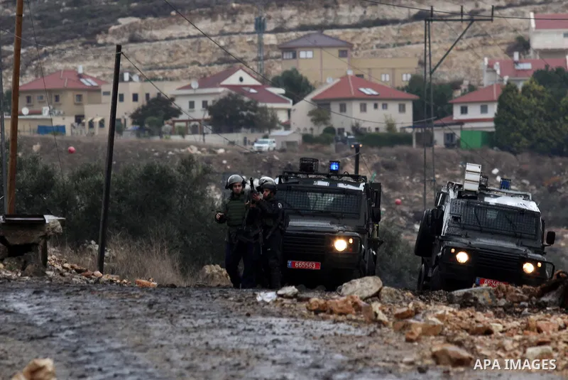 Israeli security forces take position during clashes with Palestinian protesters following a demonstration against the expropriation of Palestinian land by Israel in the village of Kfar Qaddum, near Nablus, in the occupi...