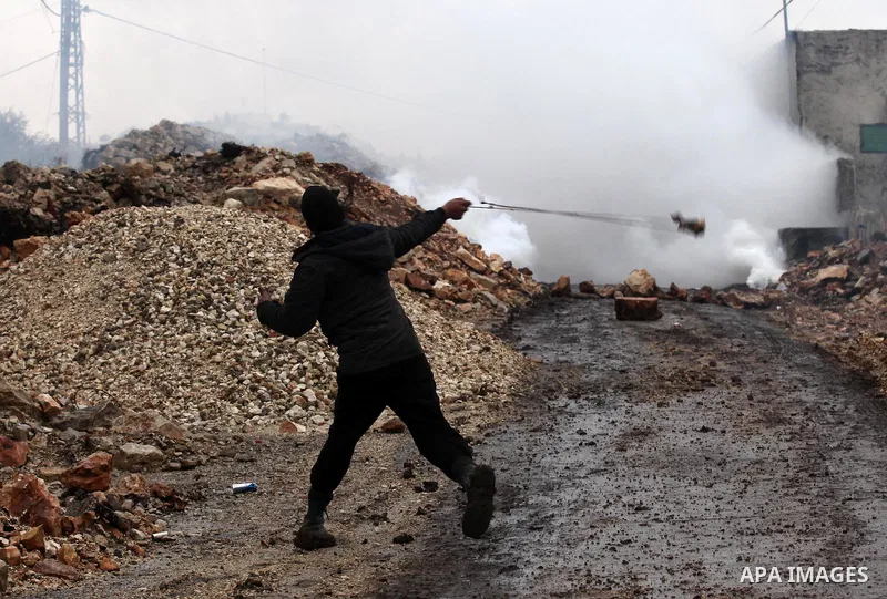 Palestinian protesters clash with Israeli security forces following a demonstration against the expropriation of Palestinian land by Israel in the village of Kfar Qaddum, near Nablus, in the occupied West Bank on Decembe...