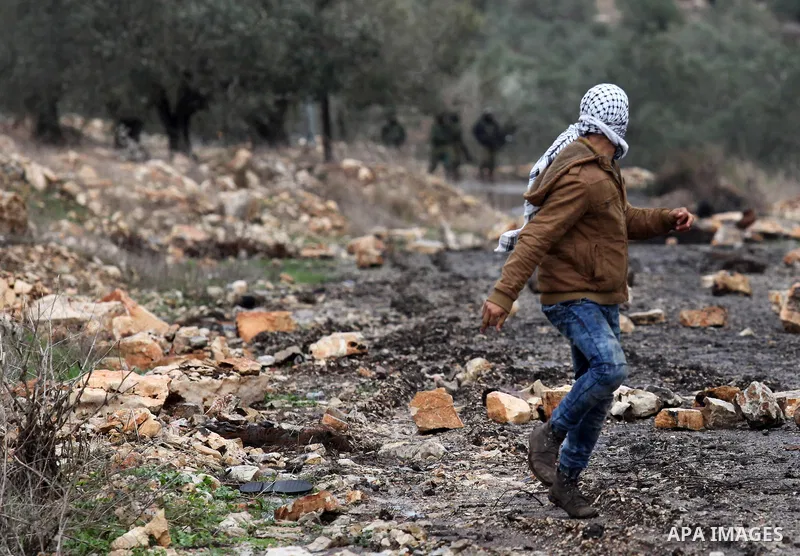 Palestinian protesters clash with Israeli security forces following a demonstration against the expropriation of Palestinian land by Israel in the village of Kfar Qaddum, near Nablus, in the occupied West Bank on Decembe...