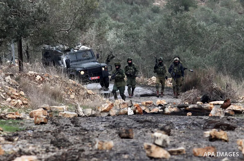 Israeli security forces take position during clashes with Palestinian protesters following a demonstration against the expropriation of Palestinian land by Israel in the village of Kfar Qaddum, near Nablus, in the occupi...