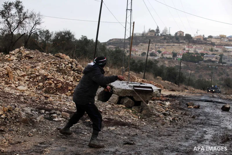 Palestinian protesters clash with Israeli security forces following a demonstration against the expropriation of Palestinian land by Israel in the village of Kfar Qaddum, near Nablus, in the occupied West Bank on Decembe...