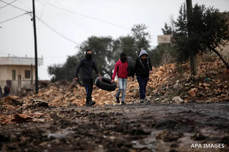 Palestinian protesters clash with Israeli security forces following a demonstration against the expropriation of Palestinian land by Israel in the village of Kfar Qaddum, near Nablus, in the occupied West Bank on Decembe...