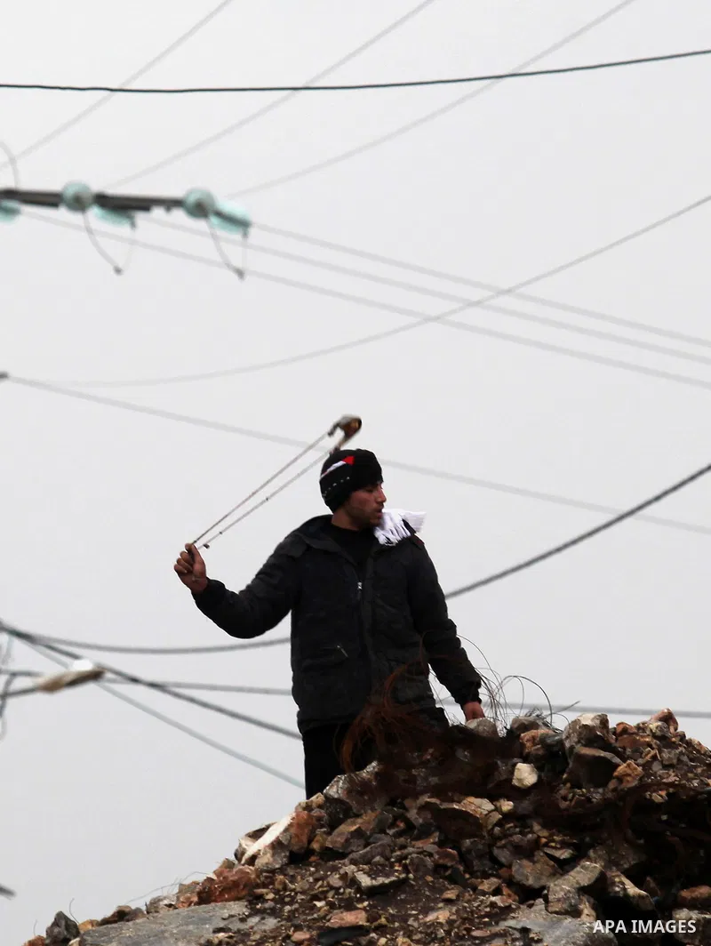 Palestinian protesters clash with Israeli security forces following a demonstration against the expropriation of Palestinian land by Israel in the village of Kfar Qaddum, near Nablus, in the occupied West Bank on Decembe...