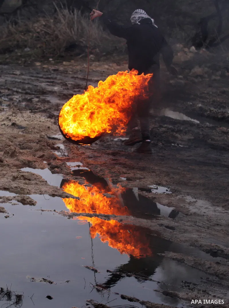 Palestinian protesters clash with Israeli security forces following a demonstration against the expropriation of Palestinian land by Israel in the village of Kfar Qaddum, near Nablus, in the occupied West Bank on Decembe...